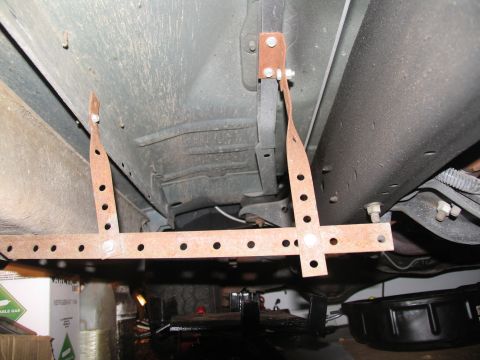 1995 Ford C-150 (Centurion Conversions) - Custom running board mounting brackets are shown attached to the underbody of a vehicle.