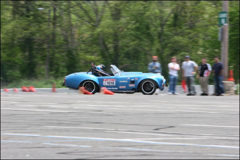 2001 Mercury Grand Marquis - A blue convertible sports car navigates an autocross course, marked with racing decals and the number 1016.
