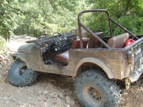 1992 Ford Bronco - This Jeep CJ-7 is equipped for off-road use, with large tires and a roll cage visible.