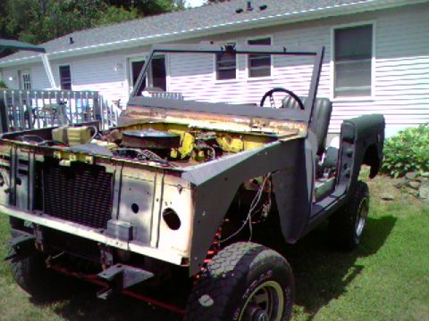 1974 Ford Bronco - This 1974 Ford Bronco is in a state of disassembly, showing its front end and exposed engine components.