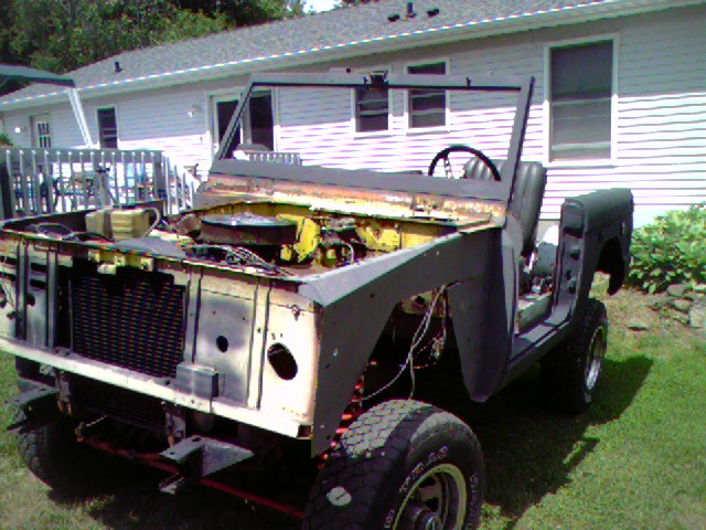 1974 Ford Bronco front end with engine exposed, partially disassembled