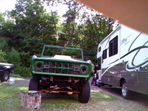 1974 Ford Bronco - Front view of a green 1974 Ford Bronco, missing its top, parked outdoors.