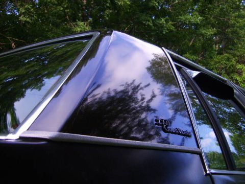 1982 Ford Crown Victoria LTD - Close-up of the rear quarter panel of a black 1982 Ford Crown Victoria LTD, showing the "Crown Victoria" badging.