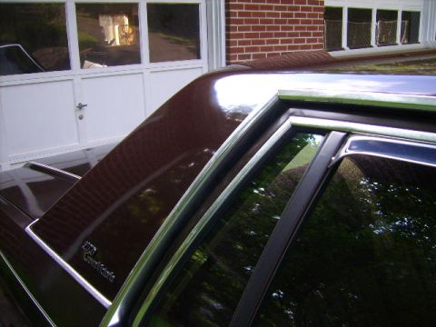 1982 Ford Crown Victoria LTD - The side profile of a 1982 Ford Crown Victoria LTD, showing its distinctive body style and brown paint.