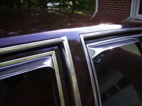 1982 Ford Crown Victoria LTD - Close-up of the side window trim and rain guard on a 1982 Ford Crown Victoria LTD.