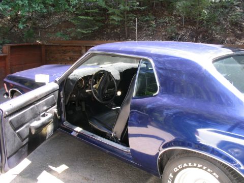1973 Ford Ranchero - Interior view of a blue coupe, likely from the early 1970s. The driver's door is open.