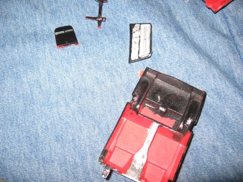 1974 Ford F-100 - The chassis of a plastic model truck is shown with various unassembled parts, suggesting a work-in-progress.