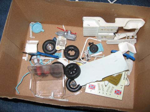 1974 Ford F-100 - Box of unassembled model kit parts, including chassis, engine, wheels, and decals.