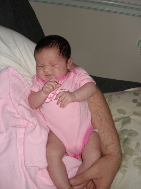 2000 Ford Crown Victoria - A newborn baby sleeps soundly while being held by an adult.