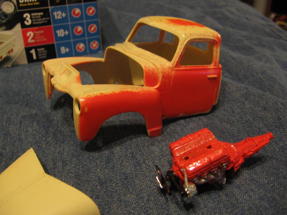 Plastic model truck body and separate engine, partially painted