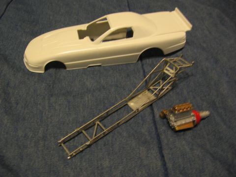 1974 Ford F-100 - This photo shows unassembled parts for a plastic model drag car, including the body, chassis, and engine.