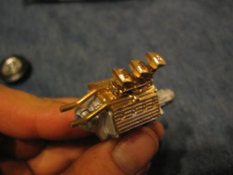 1974 Ford F-100 - A detailed model engine, possibly for a plastic model kit, is shown being held.