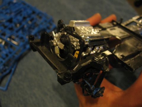 1974 Ford F-100 - A detailed plastic model engine and chassis assembly is shown, with sprues in the background.