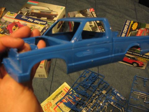 1974 Ford F-100 - Model truck body and parts scattered around, with various model kit boxes in the background.