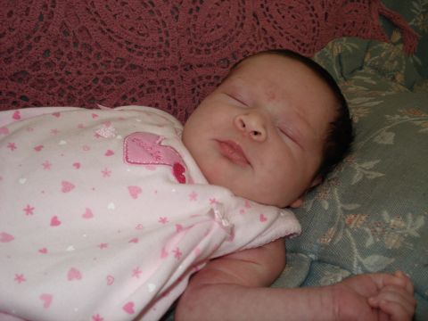 2000 Ford Crown Victoria - A baby sleeps peacefully, dressed in a pink onesie with heart patterns.