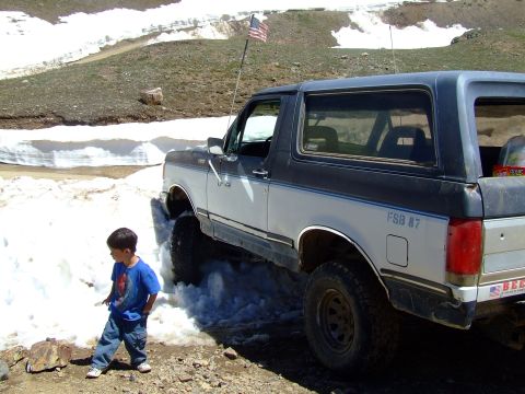 1987 Ford Bronco - This 1987 Ford Bronco navigates through snow, displaying an American flag and the 'FSB 87' designation.