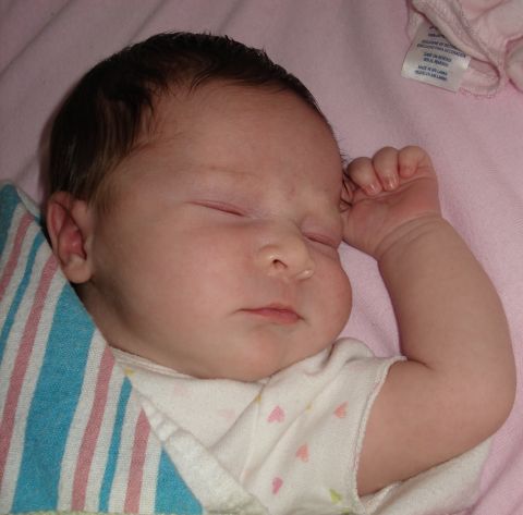 2000 Ford Crown Victoria - A close-up shot captures a sleeping infant, with a clothing tag visible in the upper right corner.