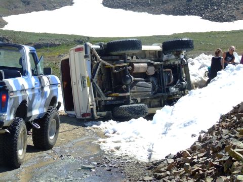 1987 Ford Bronco - An off-road excursion took a turn when this SUV ended up on its side, with another truck nearby.