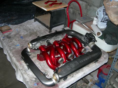 1992 Ford Taurus - Custom painted intake manifold and runners, labeled SHO 24 VALVE, sit on a table.
