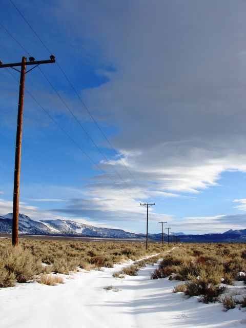 1996 Ford Bronco - A desolate winter scene with telephone poles stretching into the distance under a cloudy sky.