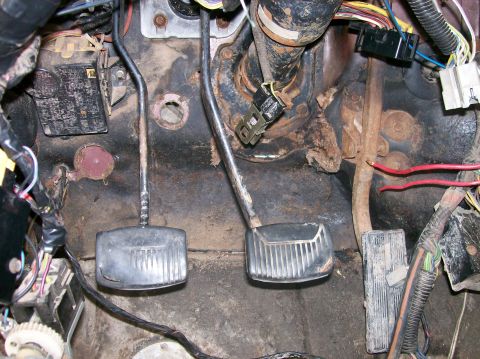 1982 Ford Bronco - Close-up view of the driver's side footwell, revealing pedals and electrical components.