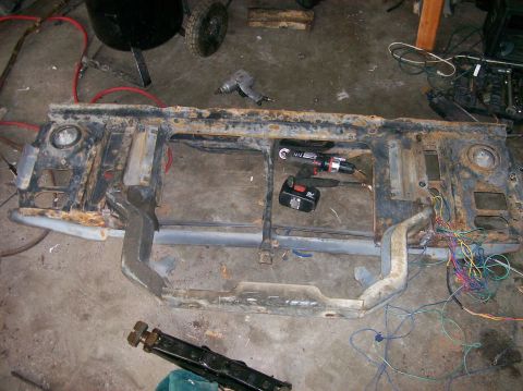 1982 Ford Bronco - This rusted front end assembly, likely from a 1982 Ford Bronco, shows signs of extensive work and wiring.