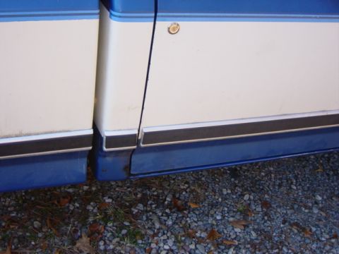 1985 Ford F-250 - Close-up of a two-tone truck's side panel, showing the door seam and lower trim.