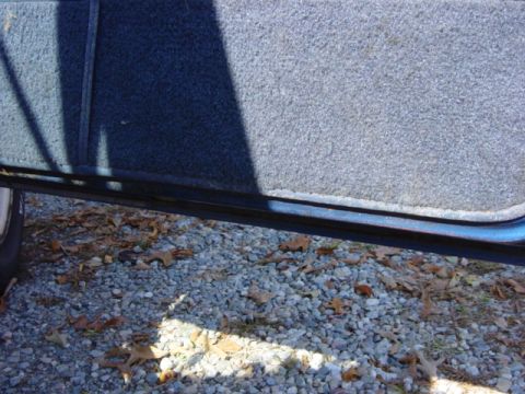 1985 Ford F-250 - Interior door panel detail with exterior ground visible below.