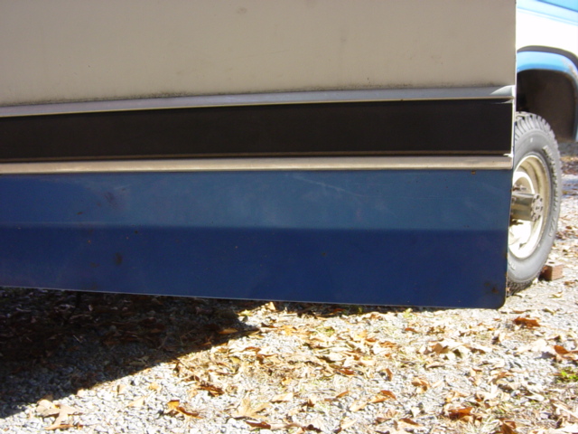 Side view of 1985 Ford F-250 door with blue and white paint and black trim