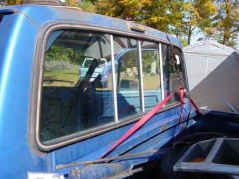 1985 Ford F-250 - Reflection shows a second pickup truck, possibly a Ford, in the background.