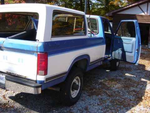1985 Ford F-250 - This 1985 Ford F-250 pickup truck is shown from the rear quarter with both doors open.