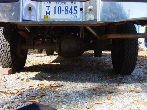 1985 Ford F-250 - The underside of a pickup truck, showing the rear differential, suspension, and tires, with a Virginia license plate visible.