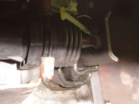 1985 Ford F-250 - Detail shot of a rubber boot and associated metal bracketry, likely from a vehicle's mechanical system.