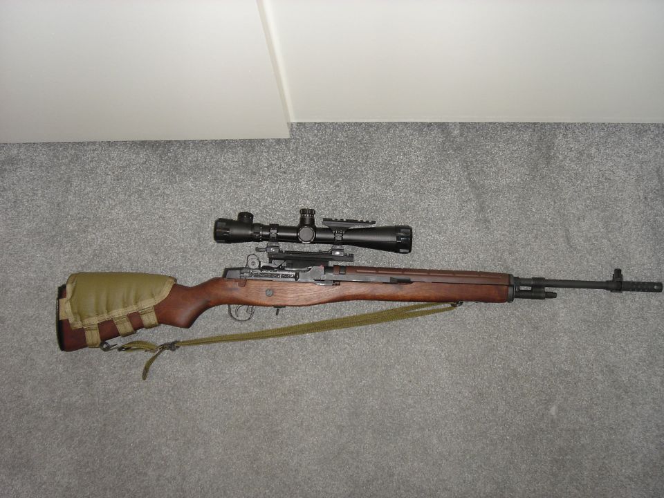 Rifle with scope and padded stock cover