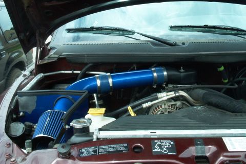 2001 Dodge 1500 - Engine bay of a 2001 Dodge 1500 with a blue aftermarket cold air intake system installed.