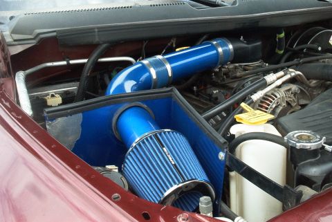 2001 Dodge 1500 - Aftermarket cold air intake system installed in the engine bay, blue filter and tubing.