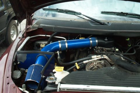 2001 Dodge 1500 - Custom blue cold air intake system installed in the engine bay of a 2001 Dodge 1500.