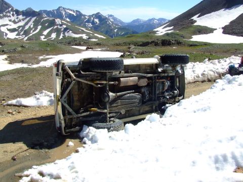 1987 Ford Bronco - This 1987 Ford Bronco has rolled onto its side in a snowy, mountainous environment.