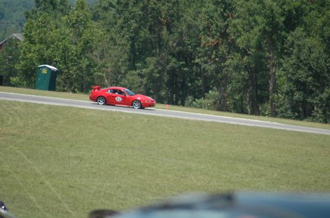 2000 Ford Mustang - Red 2000 Ford Mustang with racing number 92 on a track.