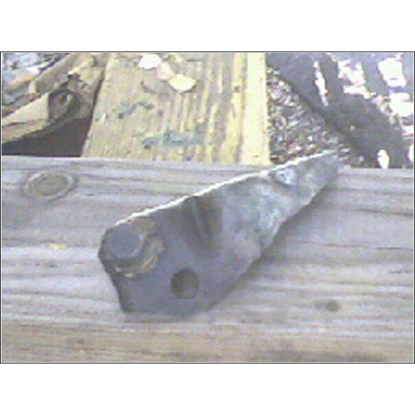 Steel triangular bracket with bolt and washer lying on a weathered wooden board