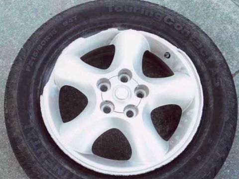 2000 Ford Taurus - The rim after the 2 impacts, dragging in the dirt, and pushing into a parking lot. The black tire easily defines where the chunks of the ri…