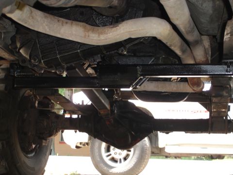 1989 Ford Bronco - Underside view of a vehicle's drivetrain components, including the transmission and rear axle.