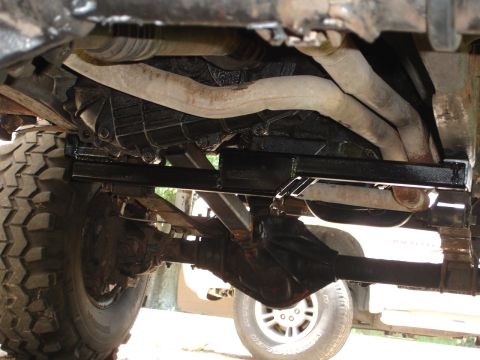 1989 Ford Bronco - Close-up of vehicle undercarriage, focusing on transmission and suspension components.