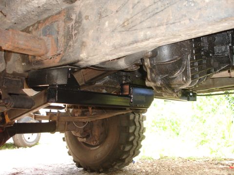 1989 Ford Bronco - Close-up of vehicle undercarriage, focusing on transmission and suspension components.