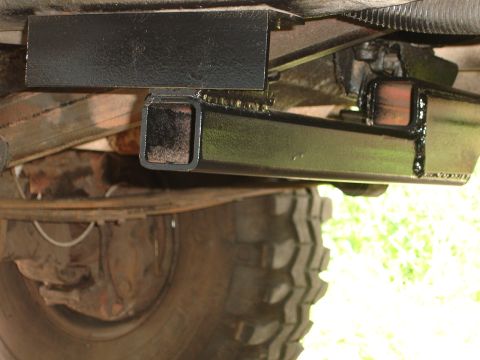 1989 Ford Bronco - Close-up view of a trailer hitch receiver assembly attached to the undercarriage of a vehicle.
