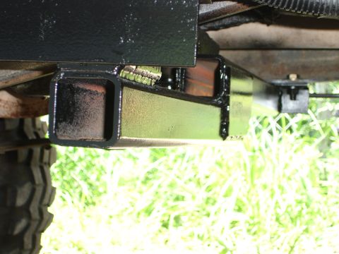 1989 Ford Bronco - Underside view of a vehicle's frame, showing a black hitch receiver and some of the tire tread.
