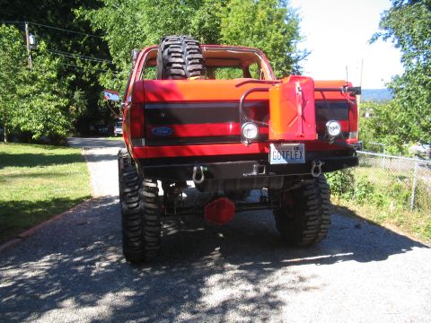 1989 Ford Bronco - Modified 1989 Ford Bronco with off-road tires and accessories, seen from the rear.