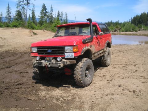 1989 Ford Bronco - This red 1989 Ford Bronco is equipped for off-road adventures with a snorkel and large tires.