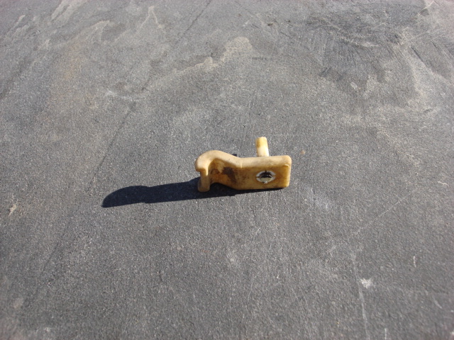 Here is a side view of the stock clip it fits in a hole in the frame and then the pin spreads the clip open and holds the line to the frame.