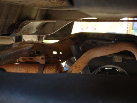 1983 Ford Bronco - it is hard to see the main line but it runs inside the frame rail behind the shock and pokes out a hole in the frame and connects to the fr…